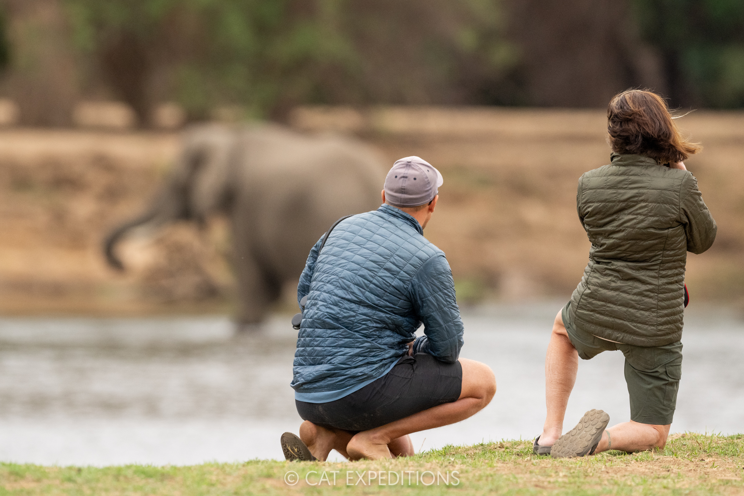 Safari guest photographing elephant on foot, under the supervision of guide Sebastian, during our Classic Safari in Zambia 2024